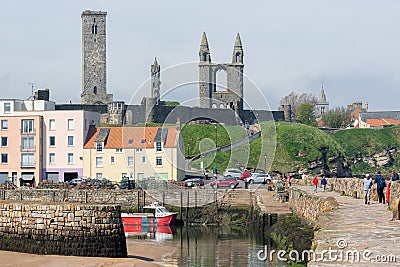 People walking at pier near harbor of Scottish St Andrews Editorial Stock Photo