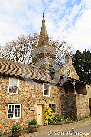 St Augustine`s church behind a quaint cottage on Front Street Alston, Cumbria, UK Editorial Stock Photo