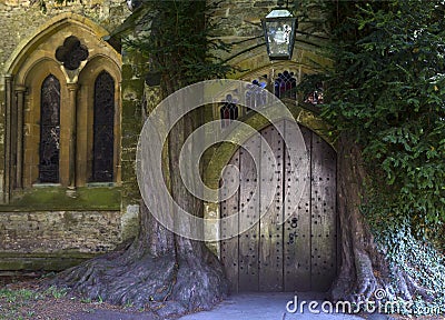 St Edward - Parish Church north door flanked by yew trees - Cotswolds - England, United Kingdom Stock Photo