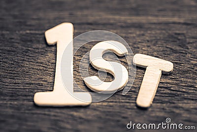 First Symbol by Wood Letters Stock Photo