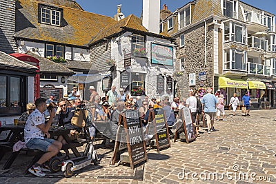Old pub with customers outside. St Ives Cornwall UK Editorial Stock Photo
