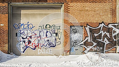 The St. Lawrence Warehouse covered with Graffiti on the doors and walls in Montreal Editorial Stock Photo