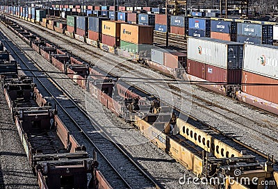 St. Louis, Missouri, United States-circa 2018-long line of train well cars and double stack freight container rail cars on tracks Editorial Stock Photo