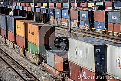 St. Louis, Missouri, United States-circa 2018-long line of train well cars and double stack freight container cars in trainyard Editorial Stock Photo