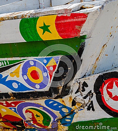 St Louis, Senegal - October 12, 2014: Colorful painted wooden fishing boats or pirogues at coast of St. Louis Editorial Stock Photo