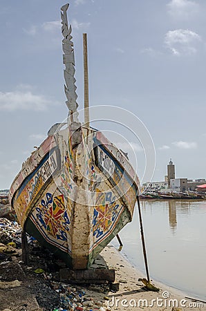St Louis, Senegal - October 12, 2014: Colorful painted wooden fishing boats or pirogues at coast of St. Louis Editorial Stock Photo