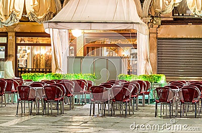 St Mark Square at night in Venice. Outdoor restaurant seats Stock Photo