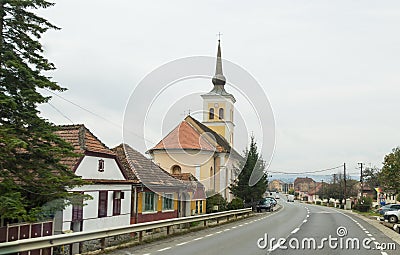 St. Nicholas Church standing on the road passing through the village of Bunesti in Romania Editorial Stock Photo