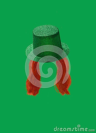 St. Patrick Day concept. Irish glittery hat and ginger curly beard on green background. Stock Photo