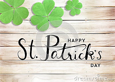 Happy St. Patrick`s Day Black Text Typography Background with Green Shamrocks on Wooden Texture Stock Photo