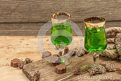 St. Patrick`s Day concept. Traditional green cocktail, sweet chocolate in the shape of clover leaves Stock Photo