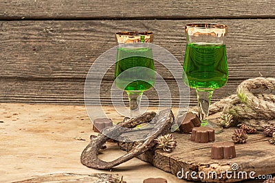 St. Patrick`s Day concept. Traditional green cocktail, sweet chocolate in the shape of clover leaves Stock Photo