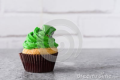 St. Patrick`s Day cupcake on gray background. Stock Photo