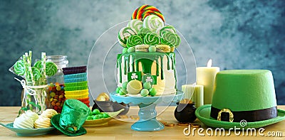 St Patrick`s Day candyland drip cake and party table. Stock Photo