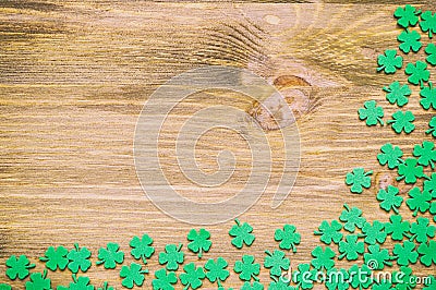 St Patricks Day background, bright green quatrefoils on texture wooden surface, free space for St Patrick text Stock Photo