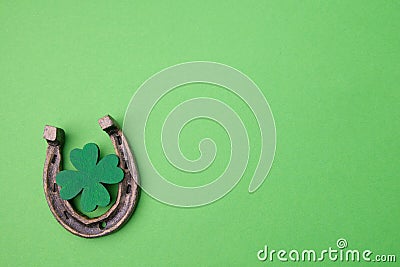 St. Patricks day, lucky charms. Horesechoe and shamrock on green background Stock Photo