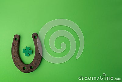 St. Patricks day, lucky charms. Horesechoe and shamrock on green background Stock Photo