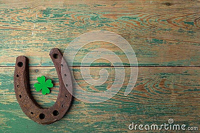 St. Patricks day, lucky charms. Horesechoe and shamrock on wooden background Stock Photo