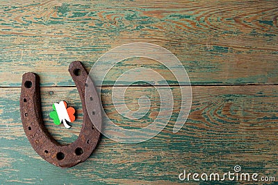 St. Patricks day, lucky charms. Horesechoe and shamrock on wooden background Stock Photo