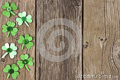 St Patricks Day side border of shamrocks over rustic wood Stock Photo