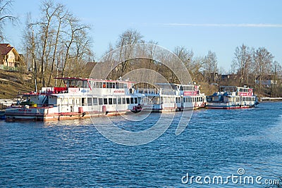 Parking of tourist motor ships `Moscow` on the river Izhora before the summer navigation. Ust-Izhora Editorial Stock Photo