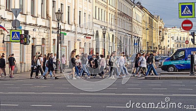 St.Petersburg,Russia-July 10, 2022: People crowd cross a pedestrian crossing Editorial Stock Photo