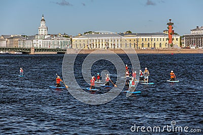 People on sup boards. massive swim on the boards. summer water activities Editorial Stock Photo