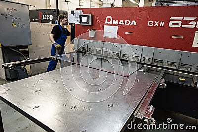 Machining by cutting large steel sheets on an automated computer Editorial Stock Photo