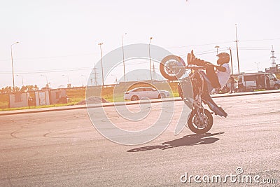 St. Petersburg, Russia - June 2019: moto rider making doing a difficult and dangerous stunt on his motorbike Editorial Stock Photo