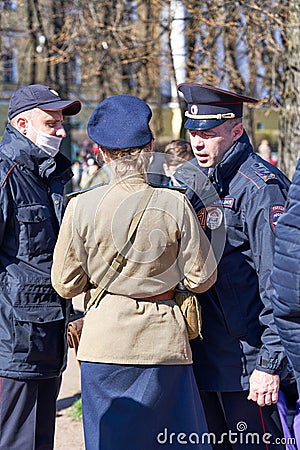 Police detain a woman in military uniform on the street of St. Petersburg Editorial Stock Photo