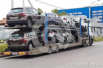 a truck is transporting many new Volkswagen cars on the platform Editorial Stock Photo