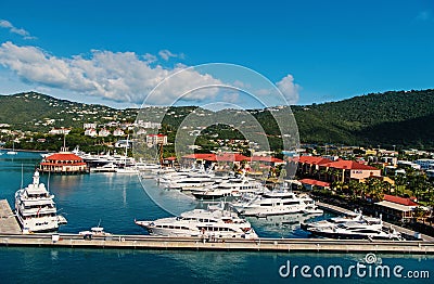 Yachts moored at sea pier on mountain landscape. Sea port and town on sunny blue sky. Luxury travel on boat, water Editorial Stock Photo