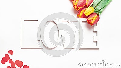 St. Valentine or Mother`s Day. Beautiful tulips, pink ribbon on light background. Day of birth. Greeting card Stock Photo