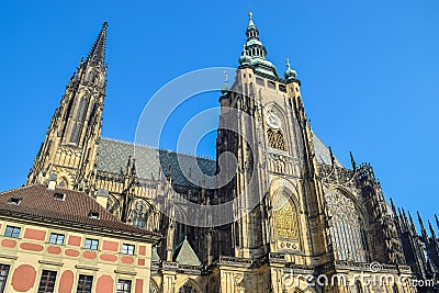 St. Vitus Cathedral with green roof and watch on tower under the sunlights in Prague Stock Photo