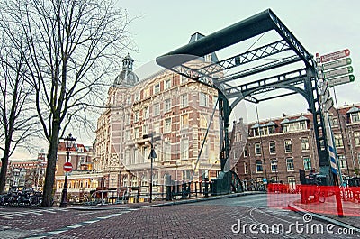 Staalstraat Bridge, iron lift bridge on Kloveniersburgwal Canal in Amsterdam, Netherlands, early in winter Stock Photo