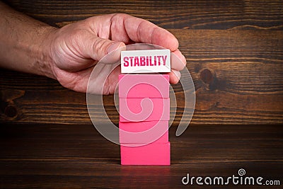 Stability Concept. Pink blocks in a pile on a wooden texture background Stock Photo