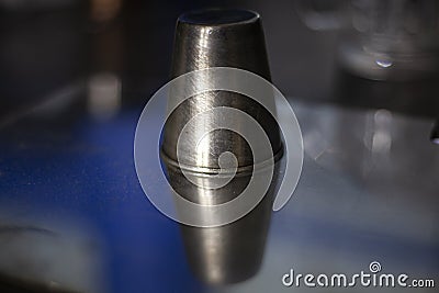 A stack for alcohol made of metal. Abstract background of metal and glass. Composition with the subject. The object in relation to Stock Photo