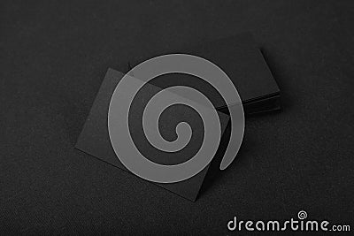 Stack Of blank black business cards on textile background Stock Photo