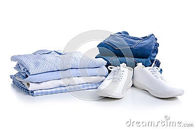 Stack blue shirt and jeans, white sneakers Stock Photo