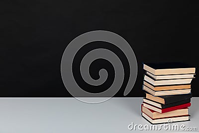 stack of books on a black background science education culture training Stock Photo