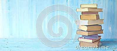 Stack of books on blue grungy background Stock Photo