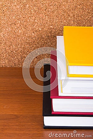 Stack of Books with Cork Board Stock Photo