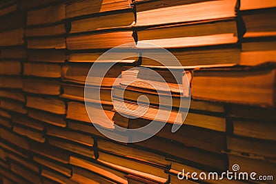 A stack of books covered with yellow light Stock Photo