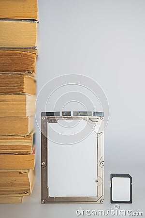 Stack of books, hard disk drive and memory card. Stock Photo