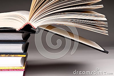 A stack of books with one open Stock Photo