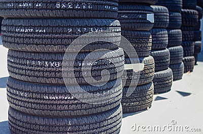 Stack of Brand New Automobile Black Tyres Stock Photo