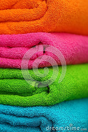 Stack of bright color towels, closeup Stock Photo