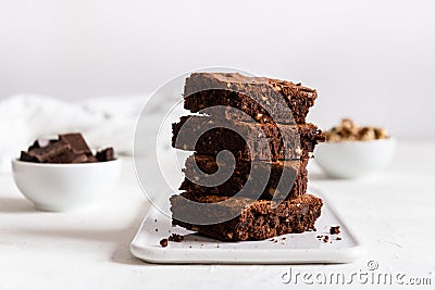 A stack of chocolate brownies on white background, homemade bakery and dessert. Bakery, confectionery concept. Side view Stock Photo
