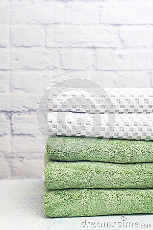 stack clean bath towels colorful cotton terry textile in bathroom white brick background Stock Photo