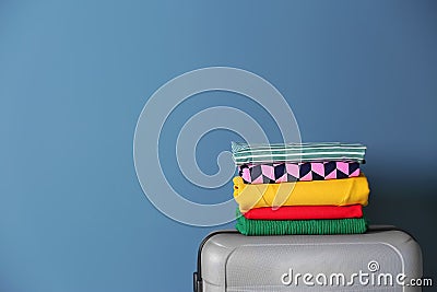 Stack of clothes on suitcase Stock Photo